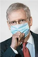  ?? DREW ANGERER/GETTY ?? Sen. Mitch McConnell’s use of masks stands in contrast to President Trump’s unwillingn­ess to wear face coverings.