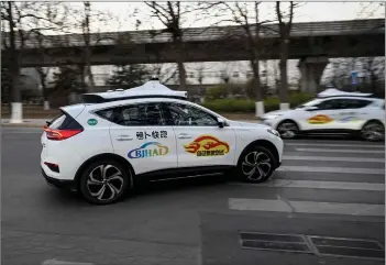  ?? — AFP photo ?? The photo shows an Apollo Go autonomous taxi driving on a street in Yizhuang, a town of Daxing District, in the southeast suburbs of Beijing.