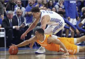  ?? JAMES CRISP - THE ASSOCIATED PRESS ?? Kentucky’s Reid Travis, top, and Tennessee’s Grant Williams chase down a loose ball during the first half of a game in Lexington, Ky., Saturday.