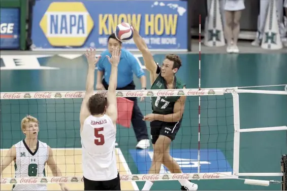  ?? UNIVERSITY OF HAWAI‘I ATHLETICS photo ?? University of Hawaii outside hitter Colton Cowell hits the ball against Harvard’s Griffin Schmit as Rainbow Warriors libero Gage Worsley looks on during UH’s win in the Raising Cane’s Rainbow Warrior Classic on Jan. 10, 2020. UH starts its 2021 slate Sunday at UC Irvine.