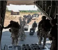  ?? AP/U.S. Air Force/TECH. SGT. MICAH THEURICH ?? Soldiers of
the East Africa Response Force file off a U.S. C-130 in Juba, South Sudan, on Wednesday in this photo released Saturday by the Air Force. The soldiers were part of a team deployed to help evacuate civilians.