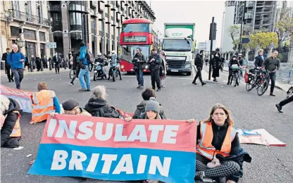  ?? ?? Rules for thee, but not for me: Insulate Britain protesters at Parliament Square. Its leader, Liam Norton, lives in a single-glazed home with gas central heating and no insulation