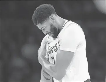  ?? Robert Gauthier Los Angeles Times ?? ANTHONY DAVIS, shown clutching his shoulder against Charlotte on Sunday at Staples Center, is expected to play Friday against the Dallas Mavericks. Teammate Kyle Kuzma could make his season debut.