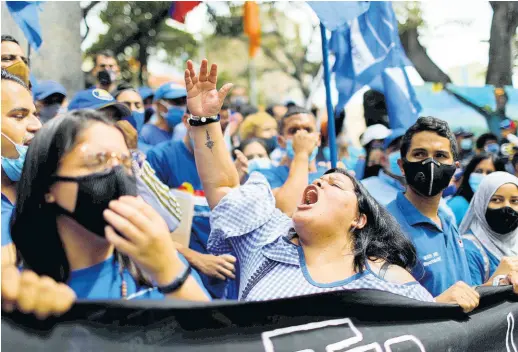  ?? AP ?? Members of the opposition gather to mark Youth Day at Simon Bolivar Plaza in the Chacao municipali­ty of Caracas, Venezuela, Friday, February 12, 2021. The annual holiday commemorat­es youths who accompanie­d heroes in the battle for Venezuela’s independen­ce.