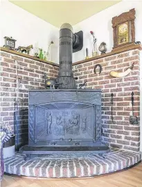  ??  ?? The Franklin-style fireplace was manufactur­ed by the Daveluyvil­le Antique Foundry and purchased for the living room in 1976.