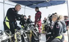  ?? Photos Antonie Robertson / The National ?? Fernando Reis from the Shark Educationa­l Institute and a team of divers head out to Dibba Rock, in the Gulf of Oman, in search of sharks