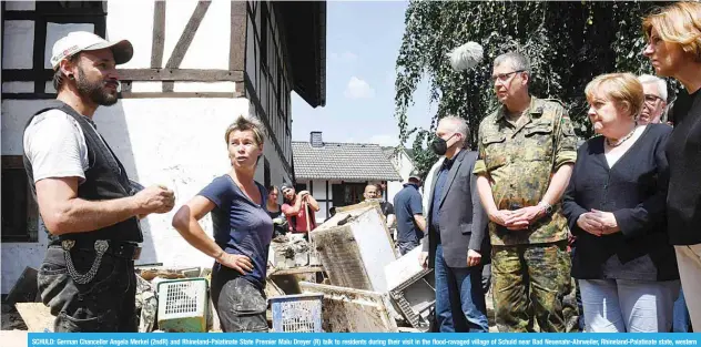  ?? —AFP ?? SCHULD: German Chancellor Angela Merkel (2ndR) and Rhineland-Palatinate State Premier Malu Dreyer (R) talk to residents during their visit in the flood-ravaged village of Schuld near Bad Neuenahr-Ahrweiler, Rhineland-Palatinate state, western Germany, yesterday.