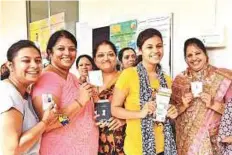  ?? PTI ?? People show their voting IDs as they cast their votes in the Karnataka Assembly elections in Hubballi yesterday.