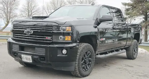  ??  ?? PHOTOS: JIL McINTOSH The Midnight Edition blacked-out accent package adds to the intimidati­ng presence of the 2018 Chevrolet Silverado 2500 Crew Cab.