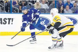  ??  ?? Lightning centre Steven Stamkos shoots the puck against Penguins defenceman Brian Dumoulin during the first period at Amalie Arena.