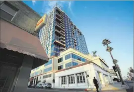  ?? Mel Melcon Los Angeles Times ?? ACTIVISTS say the city’s approval of the Sunset and Gordon residentia­l tower is invalid because the developer failed to preserve a building on the site.