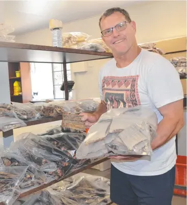  ??  ?? SNACK MAKER: All Fish for Dogs owner Glen Murray with a selection fish treats. Picture: ELISABETH CHAMPION