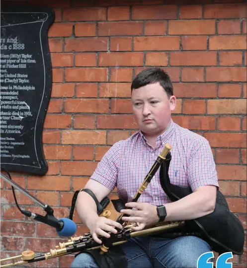  ??  ?? Darragh O Heiligh playing at the unveiling of the Taylor bothers mural on Shop Street.