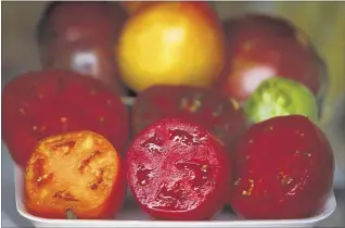  ??  ?? Peach World offers several verities of tomatoes from their stall in the Farmers Market at the Agricenter. Pictured are Brandywine, Cherokee Purple, Better Boy, Crimson Gold, Jet Star, and Bradley tomatoes.
MARK WEBER/THE COMMERCIAL APPEAL