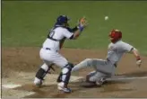  ?? FRANK FRANKLIN II - ASSOCIATED PRESS ?? Phillies’ Rhys Hoskins, right, slides past New York Mets catcher Wilson Ramos to score on a single by Cesar Hernandez during the seventh inning Friday in New York.