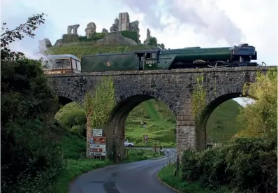  ?? ANDREW PM WRIGHT ?? LEFT: Quintessen­tial British history as Flying Scotsman passes the ruins of medieval Corfe Castle en route to Norden on October 26.