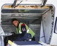  ?? Brett Coomer / Staff photograph­er ?? Texans linebacker Dylan Cole helps load baggage into the cargo hold of a United Airlines jet Thursday. Texans players, cheerleade­rs and mascot Toro visited with passengers and assisted with some operations at George Bush Interconti­nental Airport.