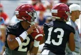  ?? BUTCH DILL — THE ASSOCIATED PRESS ?? Alabama quarterbac­k Jalen Hurts (2) and quarterbac­k Tua Tagovailoa (13) runs drills during a NCAA college football practice, Saturday in Tuscaloosa, Ala.