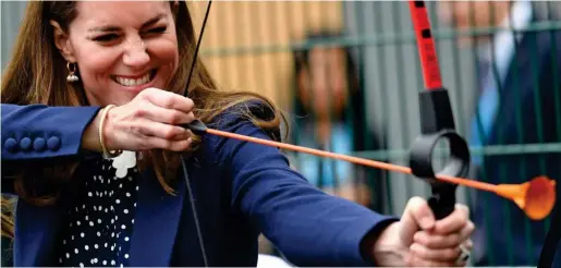  ??  ?? Taking aim: Kate tried some archery – but after missing the target she described her shot as ‘terrible’