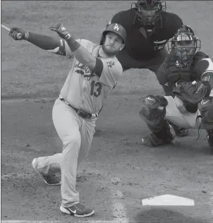  ?? SUE OGROCKI/AP ?? Max Muncy hits a grand slam as part of the Dodgers’ 11-run 1st inning during Wednesday night’s victory.