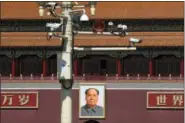  ?? ANDY WONG — THE ASSOCIATED PRESS ?? Surveillan­ce cameras are mounted on a lamp post near the large portrait of Chinese leader Mao Zedong at the Tiananmen Gate in Beijing, Friday. Chinese Premier Li Keqiang on Friday denied Beijing tells its companies to spy abroad, refuting U.S. warnings that Chinese technology suppliers might be a security risk.