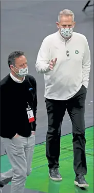  ?? STUART CAHILL / BOSTON HERALD ?? Celtics president Danny Ainge wears a mask before Friday game against the Wizards.