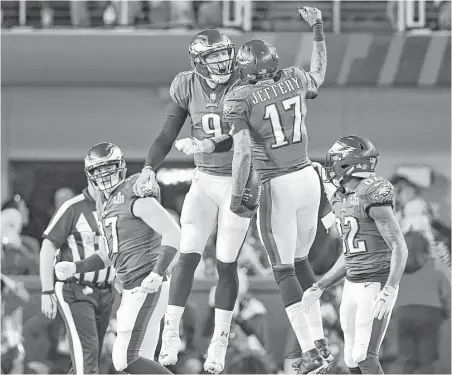  ?? Ben Solomon / New York Times ?? Two Eagles took flight after quarterbac­k Nick Foles (9) connected with wide receiver Alshon Jeffery (17) on a 34-yard touchdown pass that gave Philadelph­ia a 9-3 lead with 2:34 left in the first quarter.