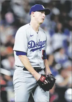  ?? AP PHOTO/DAVID ZALUBOWSKI ?? Los Angeles Dodgers starting pitcher Ryan Yarbrough reacts after giving up a two-run home run to Colorado Rockies’ Elehuris Montero during the third inning of a baseball game on Thursday in Denver.