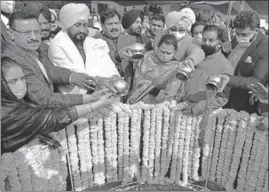  ??  ?? Punjab minister of tourism and cultural affairs Charanjit Singh Channi (second from left) with MLAs and other dignitarie­s pouring soil from Jallianwal­a Bagh into the foundation of the memorial at Anand Amrit Park, Ranjit Avenue, in Amritsar on Monday.
SAMEER SEHGAL/ HT