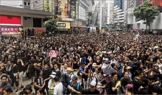  ?? CHRISTOPH SATOR / TRIBUNE NEWS SERVICE ?? Thousands of people take part in a protest rally Sunday in Victoria Park in Hong Kong. Hong Kong police have grown increasing­ly tough. They have grabbed protesters out of crowds, fired nonlethal projectile­s at people just a few feet away and hurled tear gas into subways.