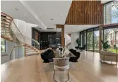  ??  ?? A red oak artistic feature wall above the dining/living rooms is among the home’s natural wood elements.