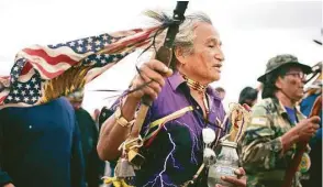  ??  ?? Above: Susan Leopold, of the Patawomeck Tribe of Virginia, watches the sun rise over the Sacred Stone Camp, where thousands of Native Americans have joined the Standing Rock Sioux tribe’s protest in Cannon Ball, N.D. Left: Phil Little Thunder Sr....