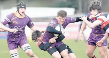  ??  ?? Determined Conor Bickerstaf­f is tackled, with Ben Johnston in support