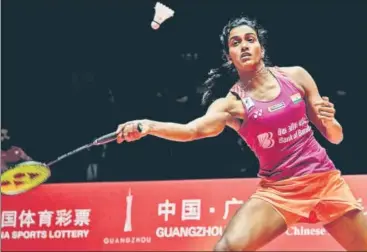  ?? AFP ?? PV Sindhu beat Japan's Nozomi Okuhara 21-19, 21-17 in one hour and two minutes in Guangzhou to lift the World Tour Finals.