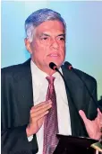  ??  ?? Prime Minister Ranil Wickremesi­nghe addressing the symposium