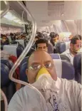  ?? — PTI ?? Passengers on board the MumbaiJaip­ur Jet Airways flight wear oxygen masks after cabin pressure dropped.