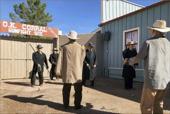  ?? PETER PRENGAMAN — THE ASSOCIATED PRESS ?? Life-sized replicas of the men who took part in a famous shootout in Tombstone, Ariz., are seen at the OK Corral in Tombstone on Saturday. The men, lawmen and cowboys, are positioned as they were during the confrontat­ion that left three dead and became one of the most famous shootouts in the Old West.