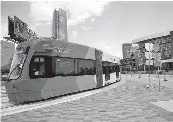  ??  ?? An OKC Streetcar slows as it approaches the Scissortai­l Park stop across from the Chesapeake Energy Arena downtown. [DOUG HOKE/ THE OKLAHOMAN]