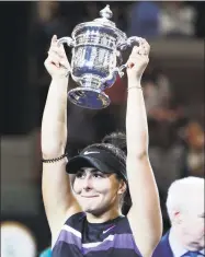  ?? Adam Hunger / Associated Press ?? Bianca Andreescu, of Canada, holds up the championsh­ip trophy after defeating Serena Williams, of the United States, in the women’s singles final of the U.S. Open last year in New York.