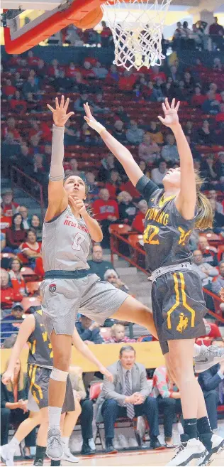  ?? JIM THOMPSON/JOURNAL ?? New Mexico’s Cherise Beynon (0) puts up a shot against Wyoming’s Marieah Campbell in the Lobos’ final home game of the season on Saturday. UNM made a nice comeback but lost 60-58.