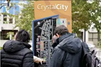  ?? ANDREW HARRER/BLOOMBERG ?? Visitors look at a Crystal City map in Arlington, Va., on Tuesday. Amazon plans to build a big chunk of its East Coast headquarte­rs in the Crystal City area and New York City.