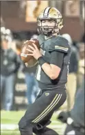  ?? / Tim Godbee ?? Calhoun quarterbac­k Gavin Gray sets for a pass on Friday night against the Peach County Trojans.