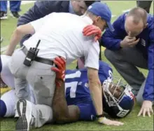  ?? BILL KOSTROUN — ASSOCIATED PRESS ?? Trainers take a look at New York Giants wide receiver Brandon Marshall after he went down making a catch during the first half of an NFL football game against the Los Angeles Chargers, Sunday in East Rutherford, N.J.