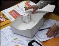  ?? PATRICK SEMANSKY — THE ASSOCIATED PRESS ?? Kelleigh Eastman, a special projects director with the Baltimore City Health Department, reaches for a package of Narcan nasal spray in Baltimore.