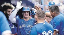  ?? THE ASSOCIATED PRESS ?? Toronto’s Matt Chapman is congratula­ted in the dugout after scoring on a single hit by George Springer in a spring training game Thursday.