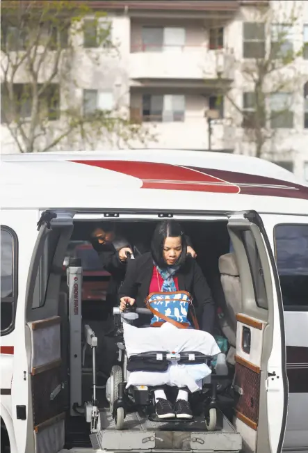  ?? Photos by Lea Suzuki / The Chronicle ?? Tony Tan maneuvers wife Emma Zhou’s wheelchair as they get out of the van with a lift Tan found on Craigslist for $7,000. The wheelchair was on eBay; it cost $2,500.