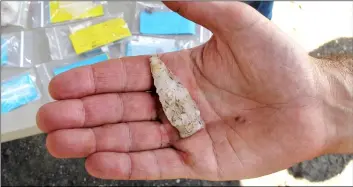  ?? AP Photo/DAVe CollIns ?? Archaeolog­ist Ross Harper holds a notched projectile, estimated to be 3,000 years old, found at the site of a Native American fort in Norwalk, Conn., on Tuesday.