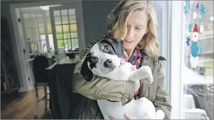  ?? THE ASSOCIATED PRESS ?? In this March 29, 2017 photo Kate Fredette, of Waltham, Mass., holds the family dog Roscoe at their home in Waltham.