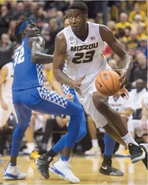  ?? (Photo by L.G. Patterson, AP) ?? Missouri's Jeremiah Tilmon, right, dribbles around Kentucky's Wenyen Gabriel during Saturday's game.