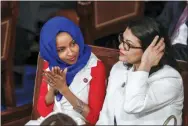  ?? J. SCOTT APPLEWHITE, FILE — THE ASSOCIATED PRESS ?? In this Feb. 5, 2019 file photo, Rep. Ilhan Omar, D-Minn., left, joined at right by Rep. Rashida Tlaib, D-Mich., listen to President Donald Trump’s State of the Union speech, at the Capitol in Washington.